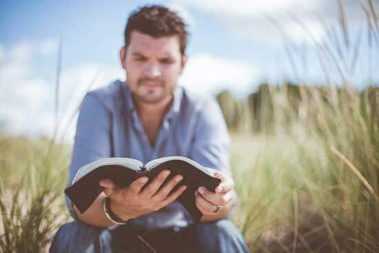 Man reading Bible as Psalmist says in Psalm 119:11 "Your word I have hidden in my heart, that I might not sin against You"
