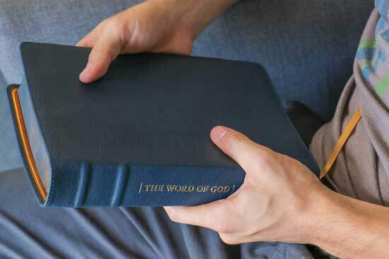 Man holding the Bible, the written Word of God which introduces us to God & His plan of salvation