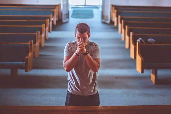 Man in Church repenting of his sins, seeking God's forgiveness that he may be clothed with the righteousness of Jesus Christ