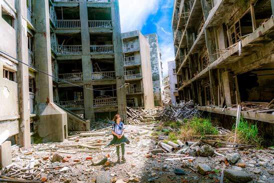 A girl standing in the midst of destroyed buildings, showing the need for a new earth