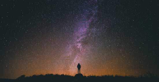 Man gazing at stars as Psalm 147:4 says in for God the Father, "He counts the number of the stars, He calls them all by name"