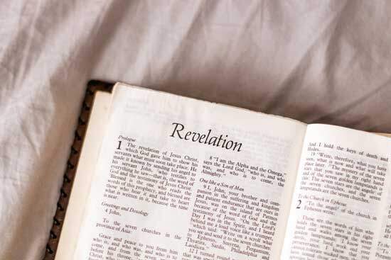 A Bible open to Revelation, which contains the three angels' messages that the remnant has been called to proclaim