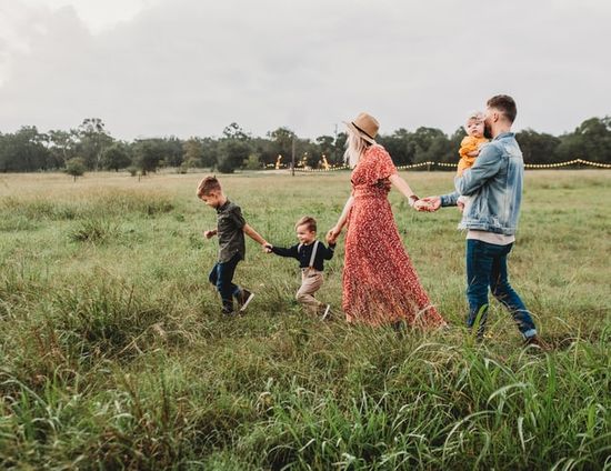 A family strolling through a field to relax