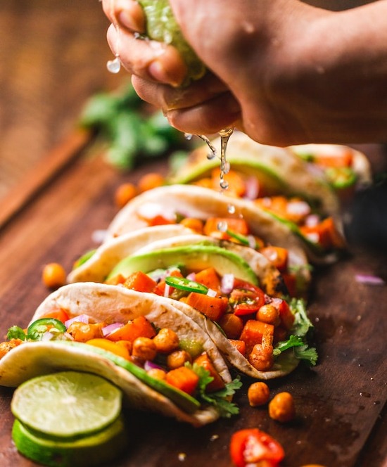 Mexican tacos with beans, avocado, and tomatoes, inspiration for the Adventist haystack