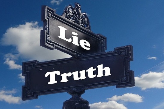 A street sign with the words lie and truth perpendicular to each other