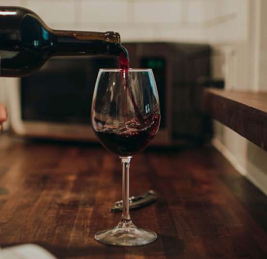 A bottle pouring red wind into a goblet