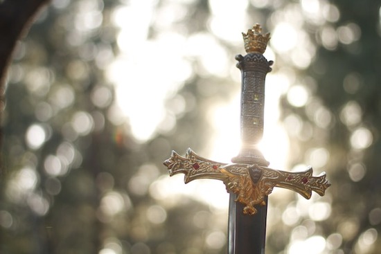 The handle of a sword glinting in the sun, representing the Word of God which is a double-edged sword