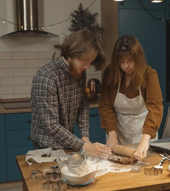A couple sharing the responsibilities of the home by cooking a meal together
