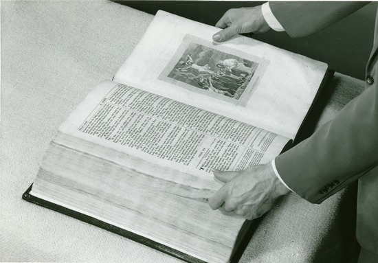 Hands opening a large Bible