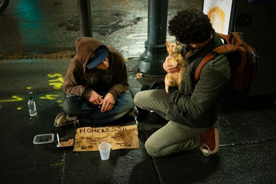 A man showing brotherly kindness by talking with a homeless man