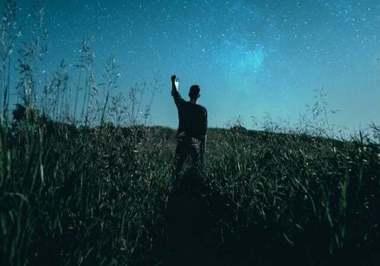 A man under a starry sky, as though he might be a prophet receiving a vision