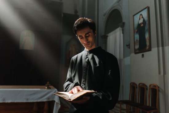 A priest reading the Bible, showing how common people didn't have access to the Bible in the Dark Ages
