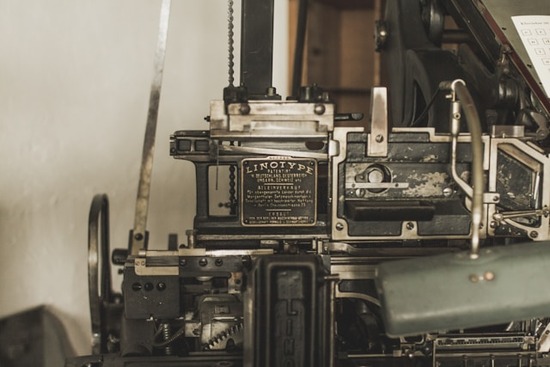 A linotype printer works to print manuscripts.