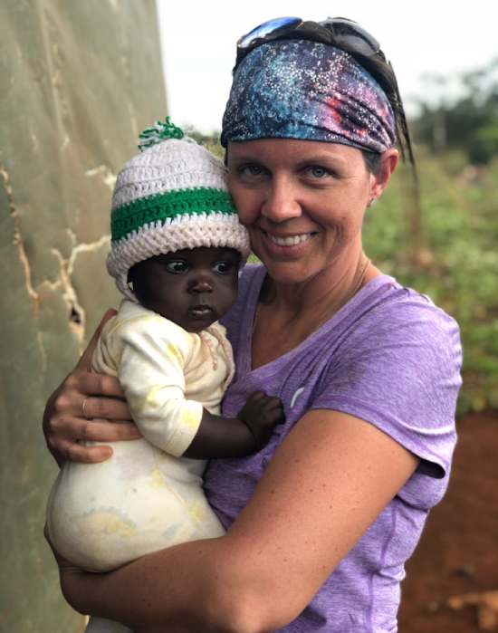 A medical missionary holding a baby she helped