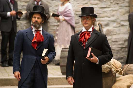 Actors depicting Adventist pioneers stand in a scene of The Hopeful holding their Bibles.