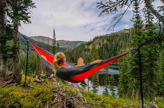 A woman relaxing in a hammock, taking in nature