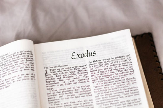 A Bible opened up to the book of Exodus.