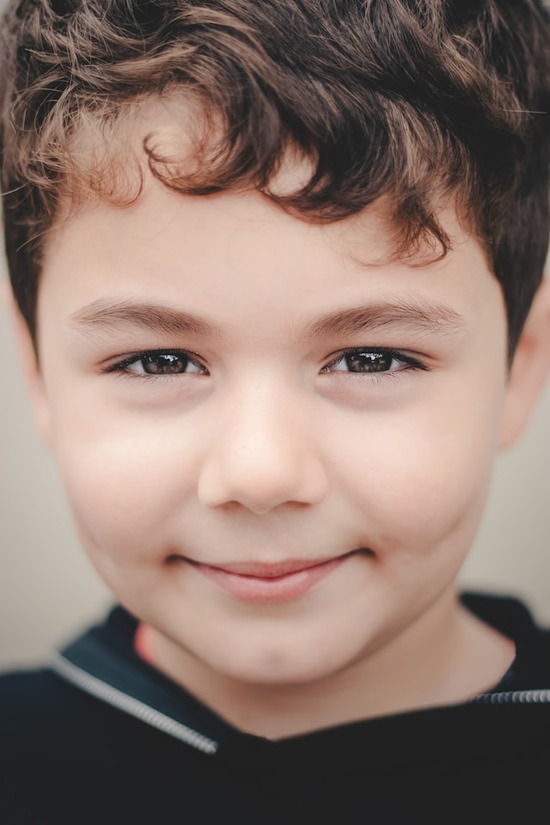 A smiling young boy.