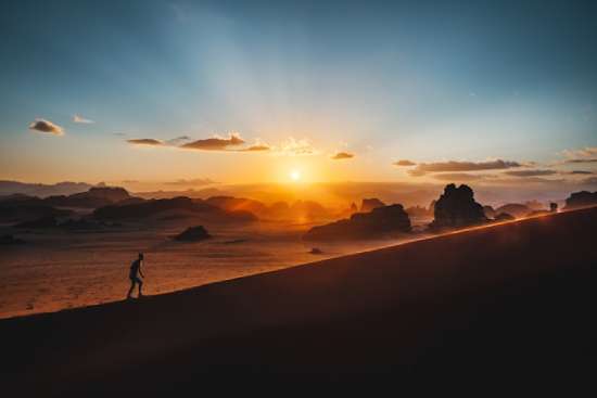 A person climbing a long mountain, emphasizing perseverance